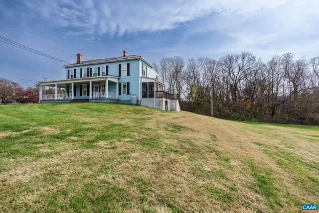 a front view of a house with a yard table and chairs