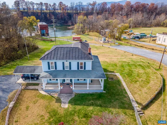 a view of a house with a yard and sitting area