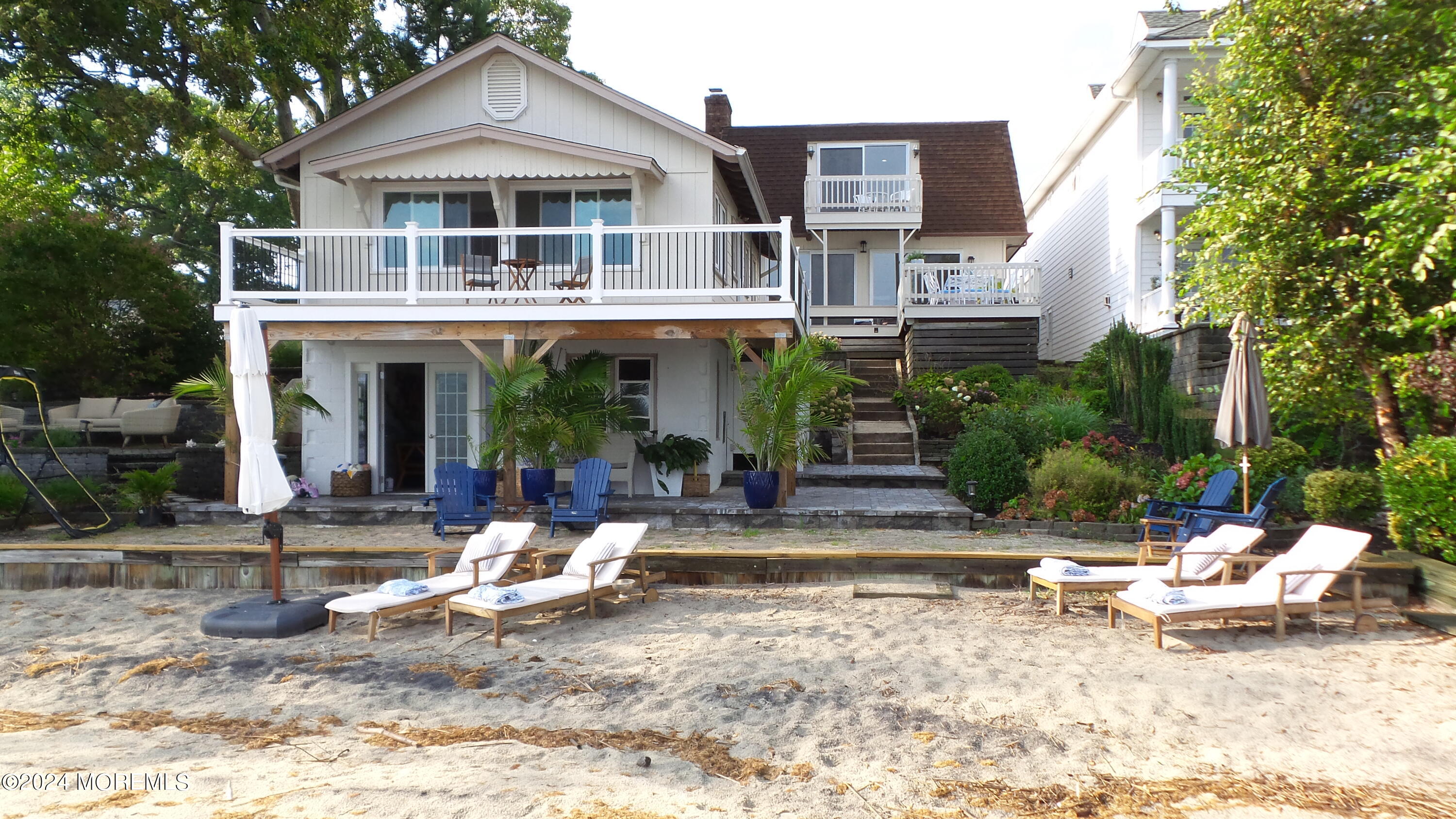 565 Princeton Avenue Brick, NJ 08724 - Photo 3 of 66 a front view of a house with swimming pool and sitting area