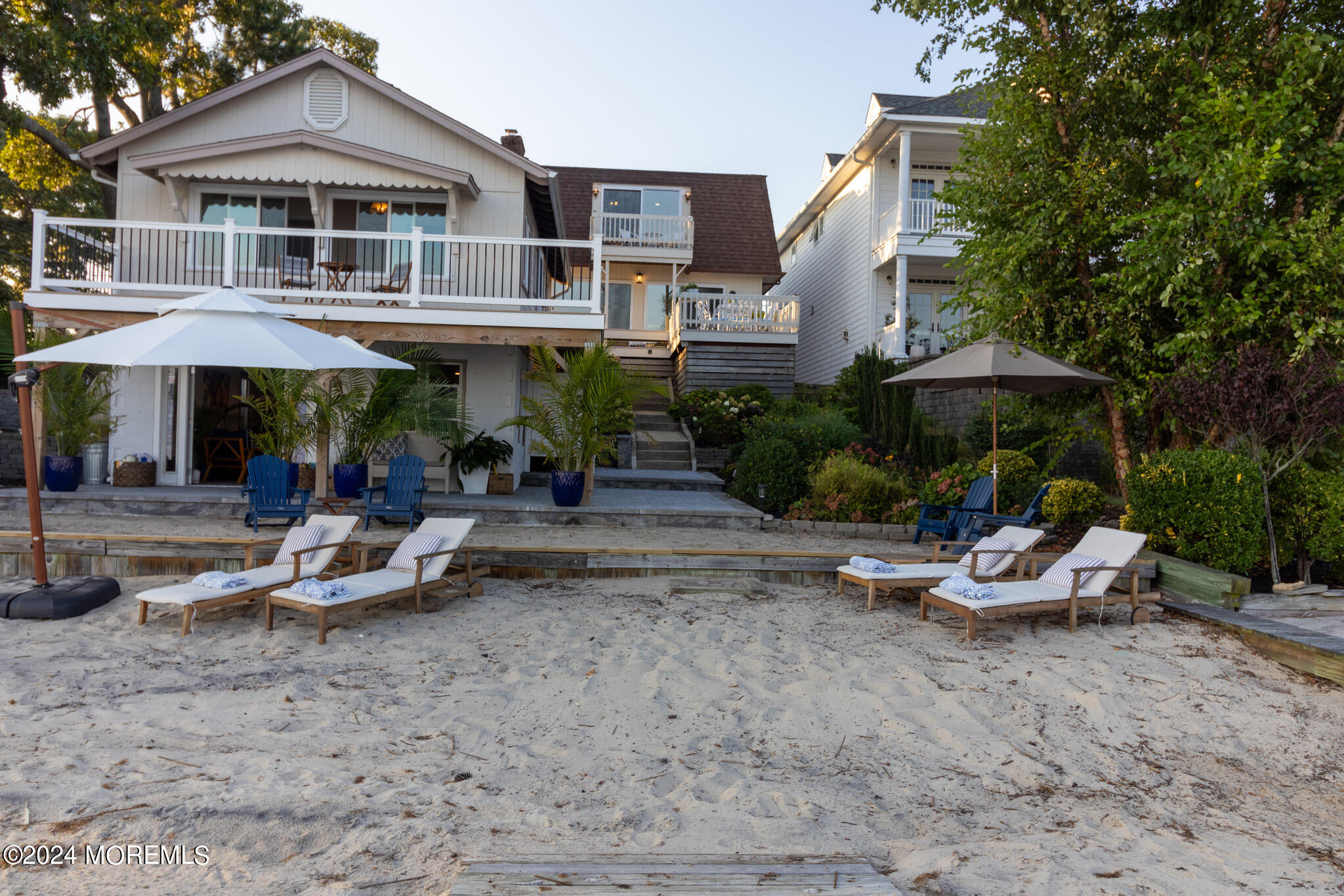 565 Princeton Avenue Brick, NJ 08724 - Photo 46 of 66 a view of a patio with a table and chairs under an umbrella