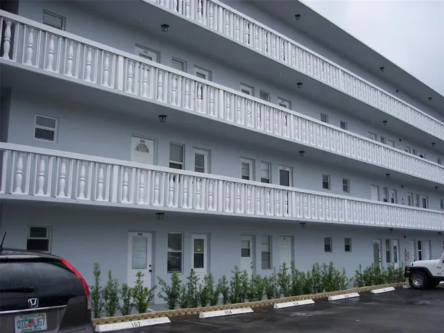 a front view of a multi story building with yard