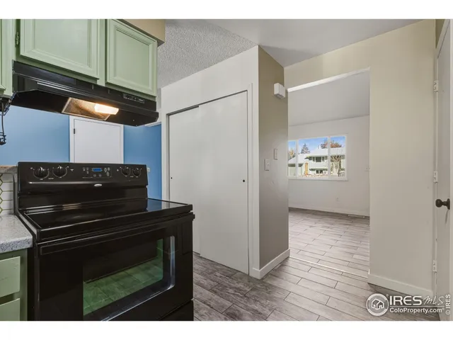a kitchen with a refrigerator and a stove top oven