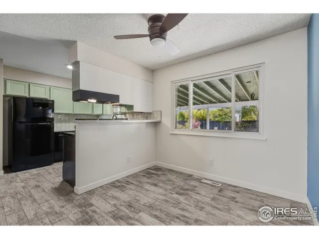 a kitchen with kitchen island a stove a refrigerator and a sink