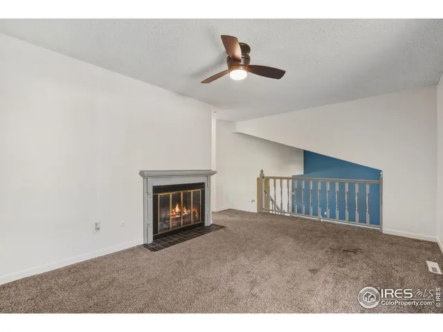 a view of an empty room with a fireplace