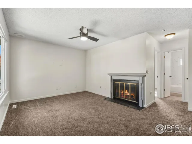 a view of an empty room with a fireplace