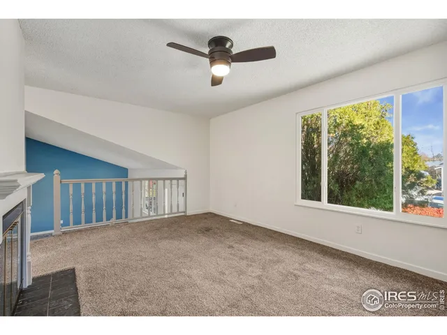 a view of an empty room and a window