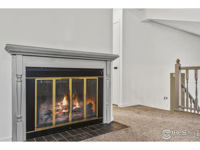 a view of a living room that has a fireplace