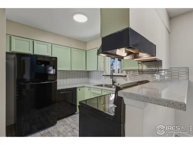 a kitchen with stainless steel appliances granite countertop a sink refrigerator and cabinets