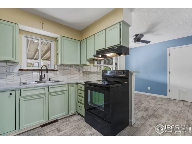 a kitchen with stainless steel appliances a sink stove and cabinets