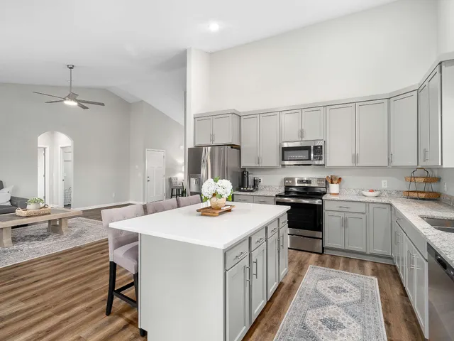 a kitchen with a stove a sink and a refrigerator