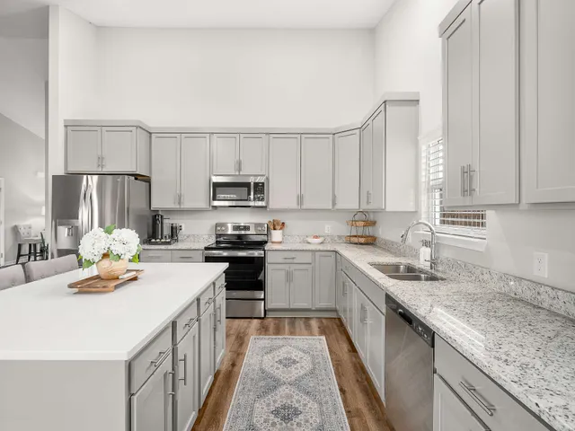 a kitchen with a sink stove and cabinets