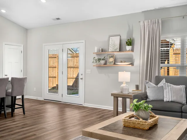 a living room with furniture and a wooden floor