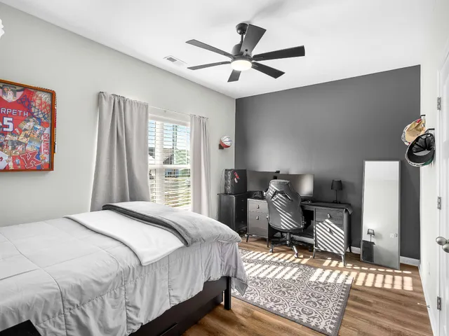 a bedroom with a bed dresser and a window