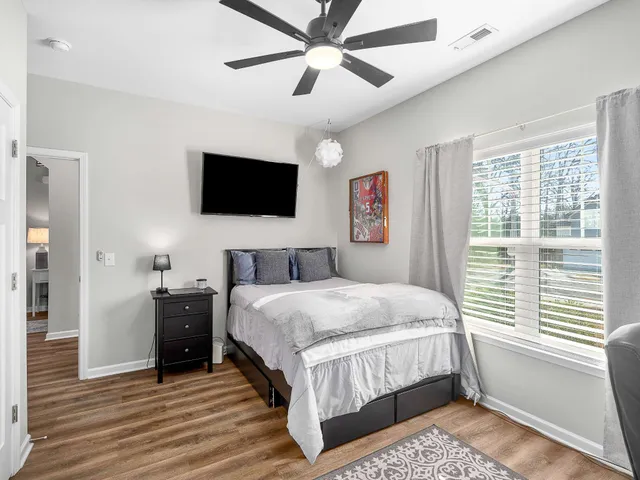 a bedroom with a bed and a flat screen tv