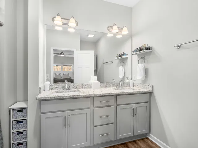 a bathroom with a granite countertop sink a large mirror and vanity