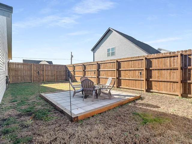 a view of a backyard with a patio