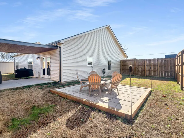 a view of a backyard with sitting area