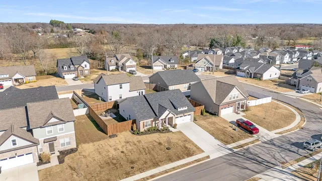 an aerial view of a house with a swimming pool and outdoor seating