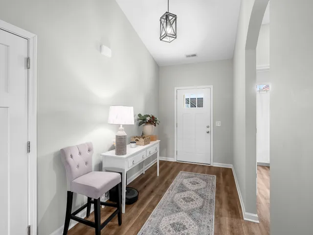 a bedroom with furniture and a rug