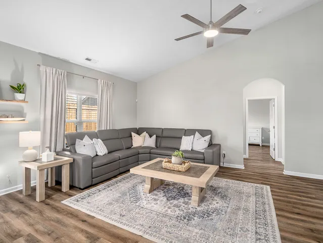a living room with furniture and a rug