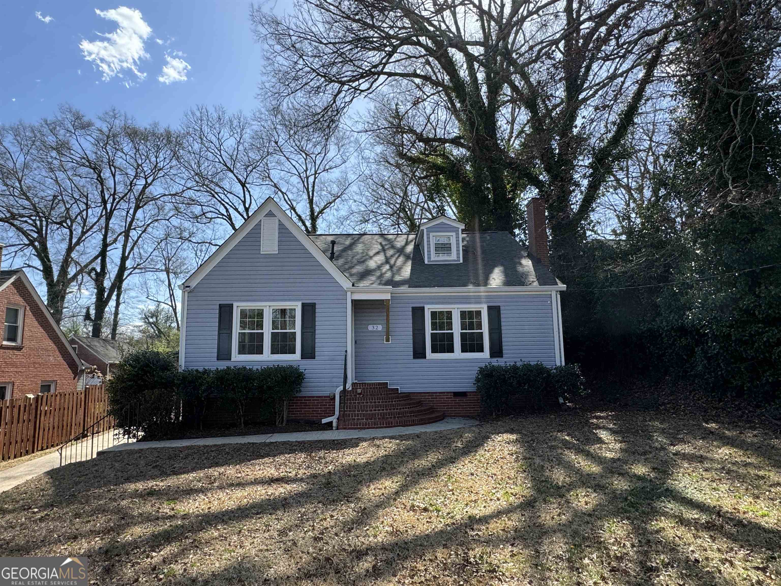 a house that has a tree in front of it