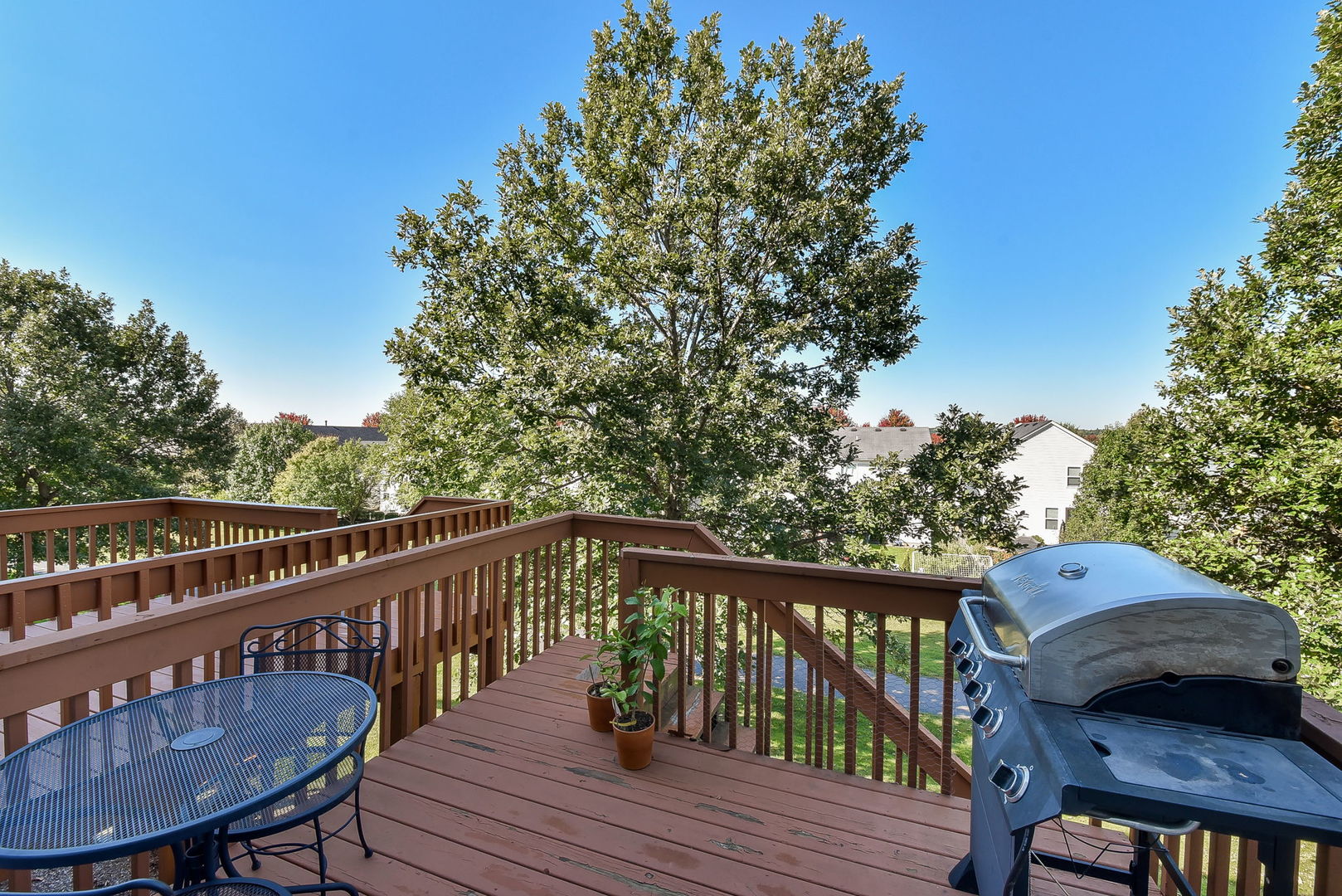 247 Grand Ridge Road St. Charles, IL 60175 - Photo 16 of 17 a view of a deck with a table and chairs with wooden floor and fence