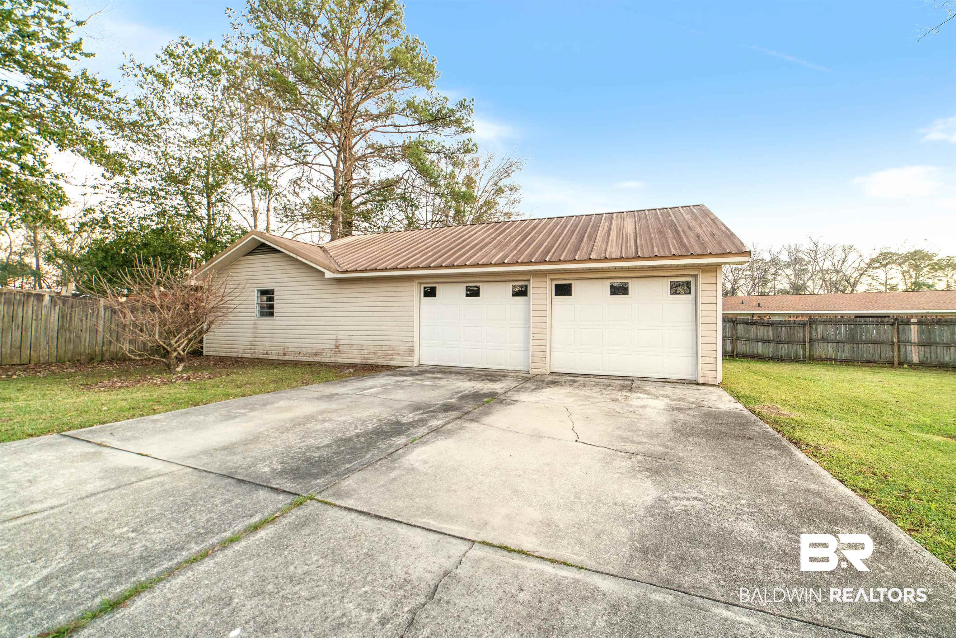 11833 Old Moffat Road Wilmer, AL 36587 - Photo 18 of 23 Garage with driveway and fence