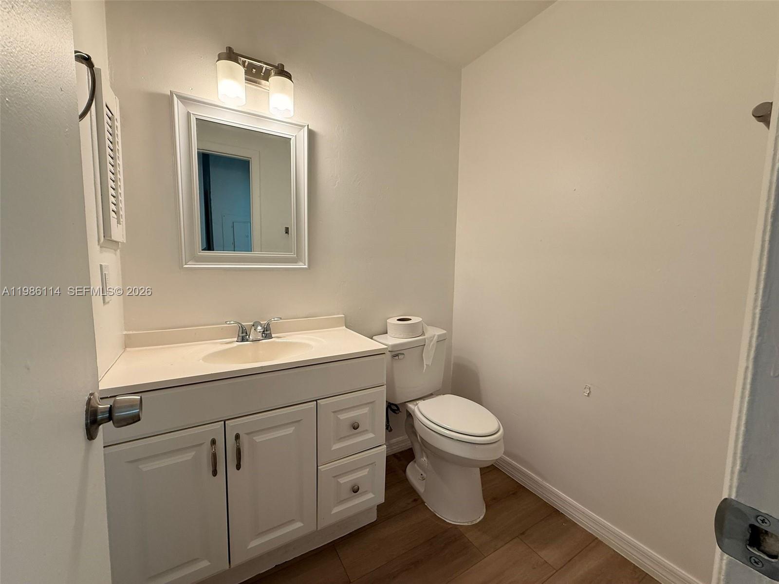 2919 Jackson Street, Unit 4 Fort Myers, FL 33901 - Photo 9 of 13 a bathroom with a toilet a sink and mirror