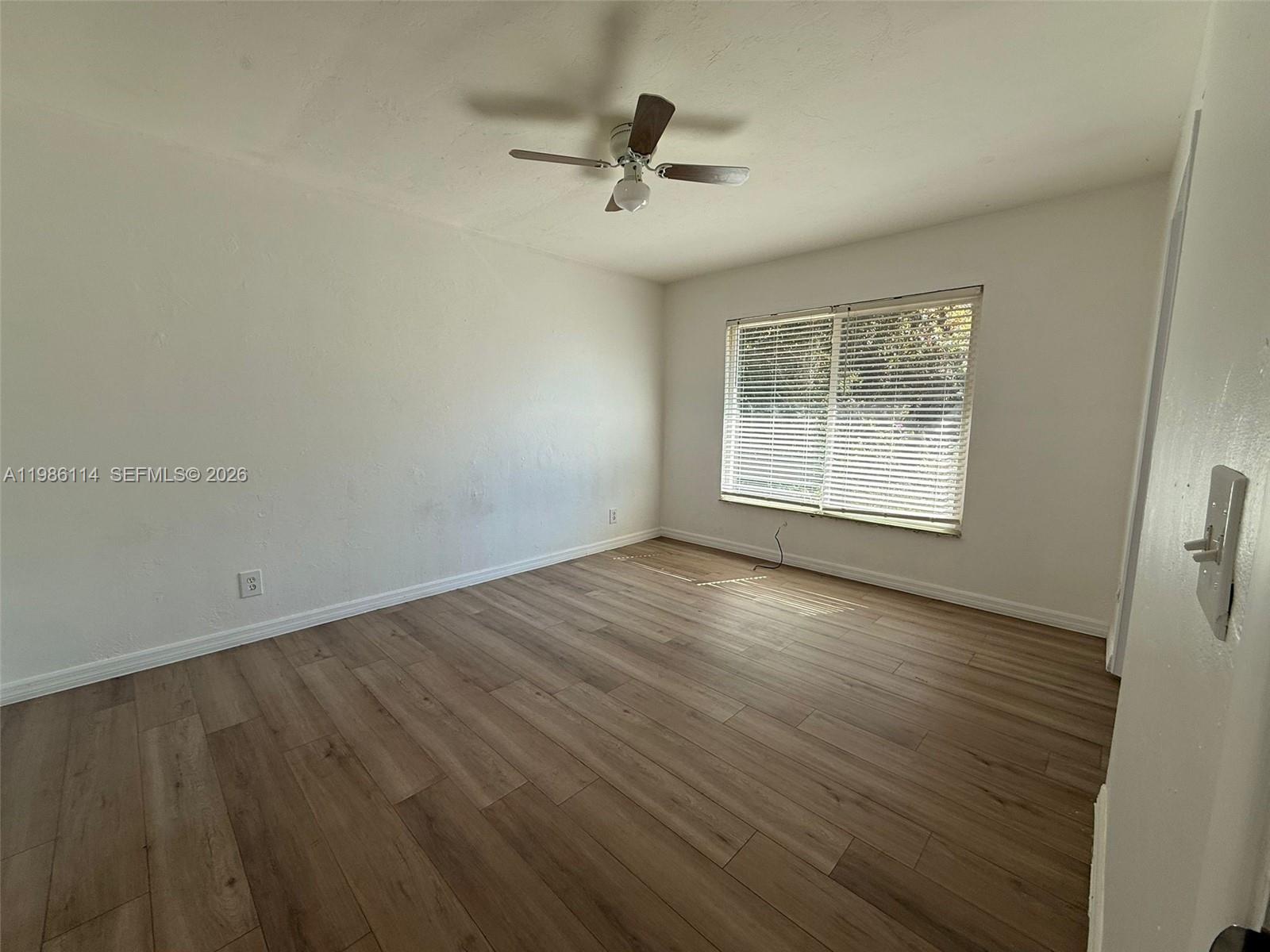 2919 Jackson Street, Unit 4 Fort Myers, FL 33901 - Photo 10 of 13 an empty room with wooden floor and windows