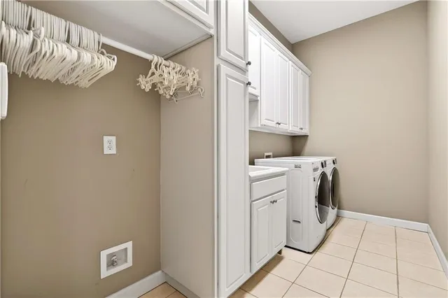 a spacious bedroom with a bed a couch and a chandelier