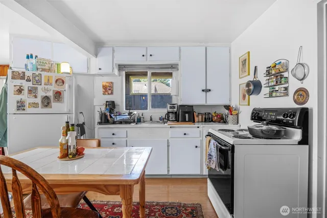 a kitchen with a sink a stove and cabinets