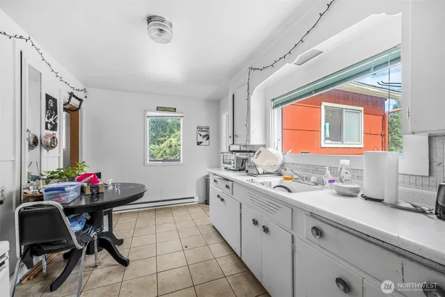 a kitchen with a sink cabinets and window