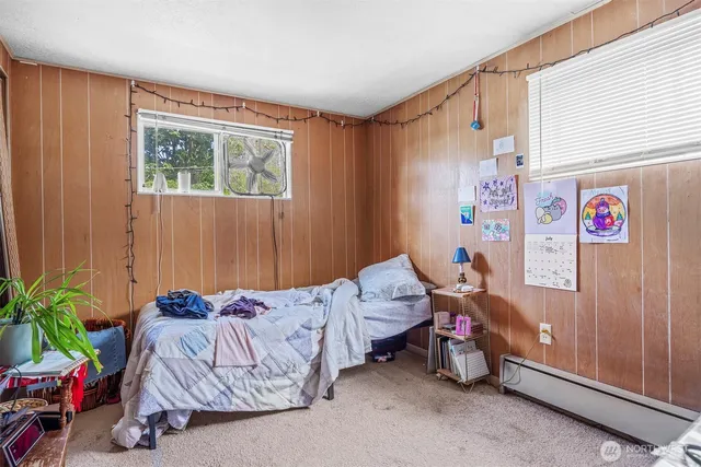 a bedroom with bed and a window