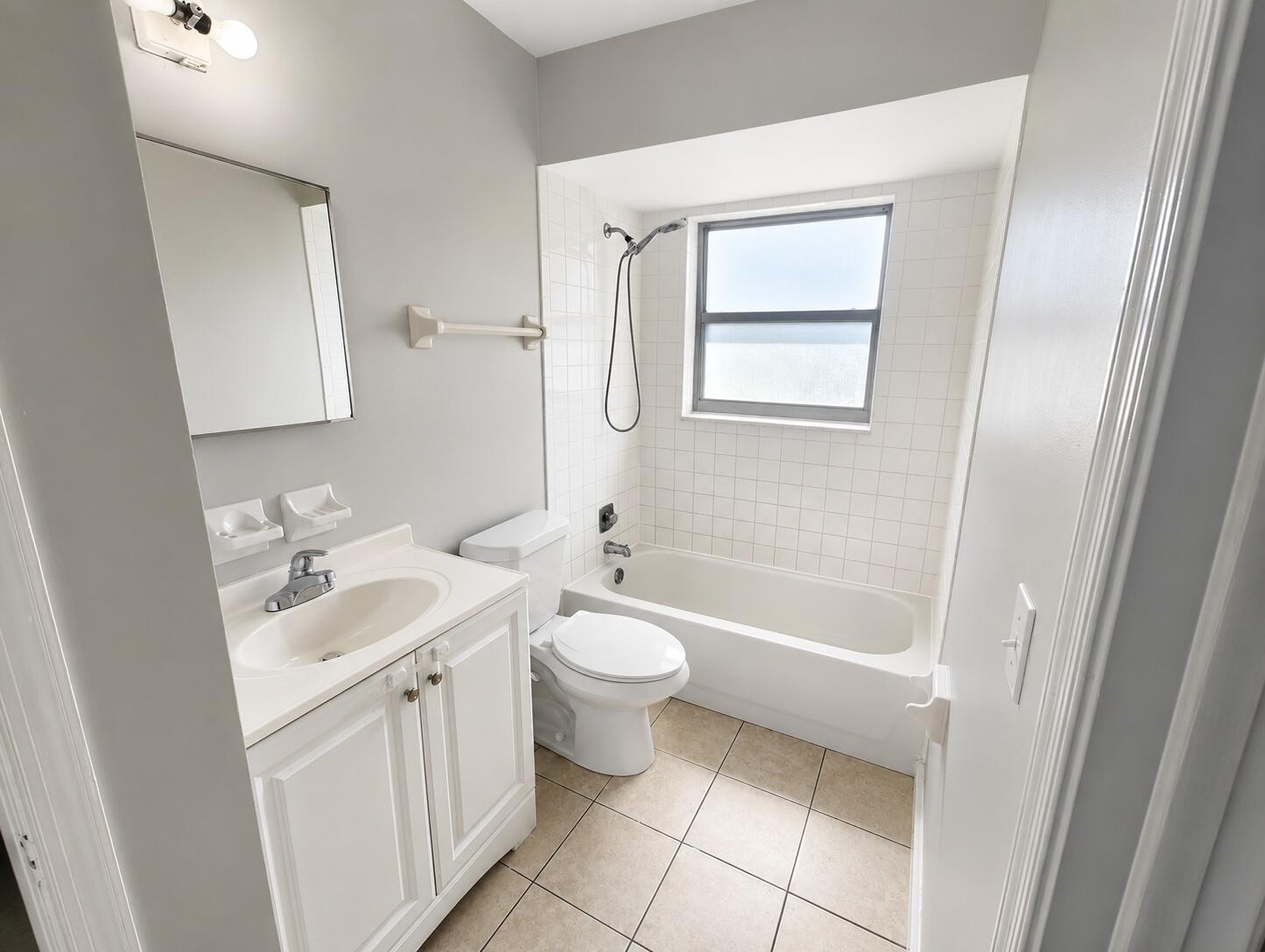 1794 Juno Road, Unit 2 North Palm Beach, FL 33408 - Photo 6 of 9 a bathroom with a sink a toilet and a bathtub