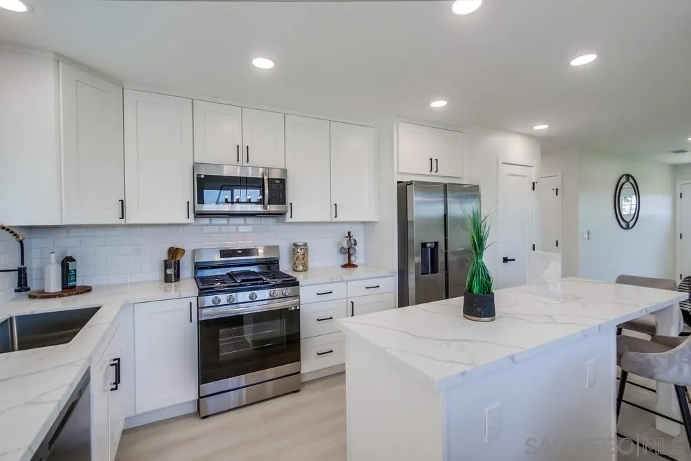 12736 Roberto Way Poway, CA 92064 - Photo 12 of 34 a kitchen with a sink a stove and refrigerator