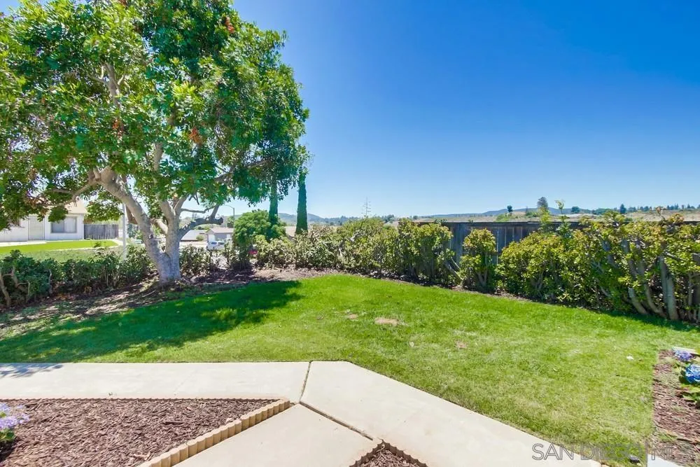 12736 Roberto Way Poway, CA 92064 - Photo 2 of 34 a view of a garden with a building in the background
