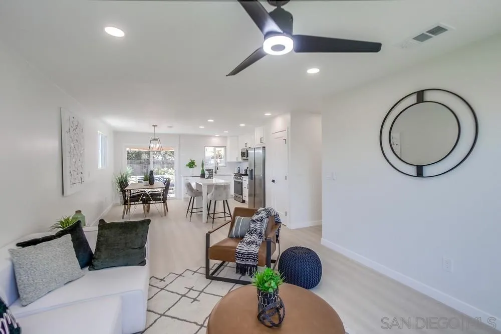 12736 Roberto Way Poway, CA 92064 - Photo 8 of 34 a living room with furniture a chandelier and a rug