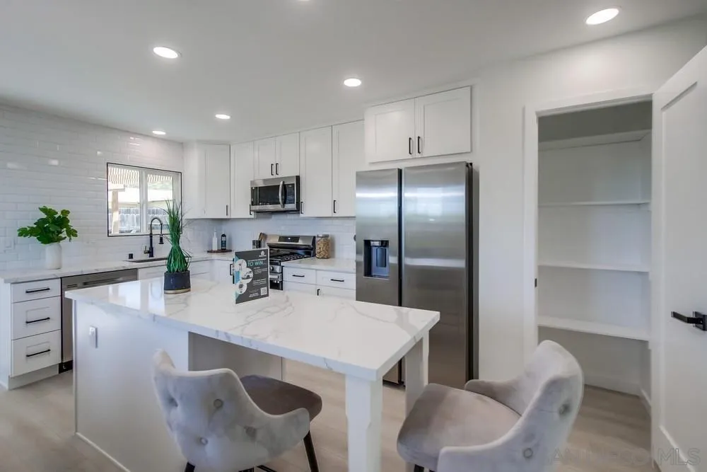 12736 Roberto Way Poway, CA 92064 - Photo 10 of 34 a kitchen with kitchen island a appliances dining table and chairs