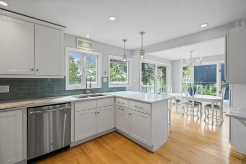 a kitchen with sink cabinets and wooden floor