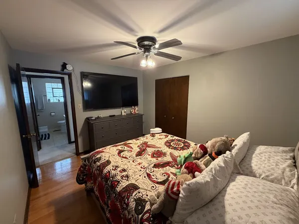 a bedroom with a large bed and a flat tv screen on a dresser