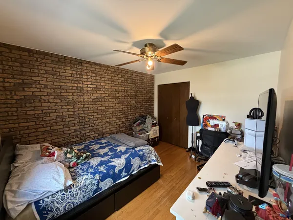 a bedroom with a bed and a chandelier