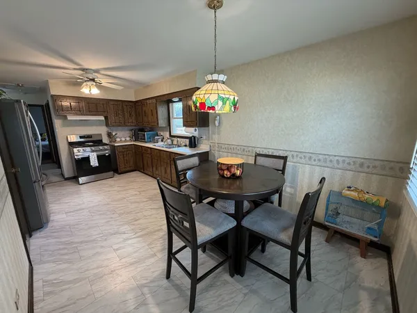 a view of a dining room with furniture and a chandelier