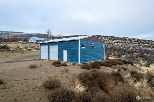 a view of a house with a wooden fence