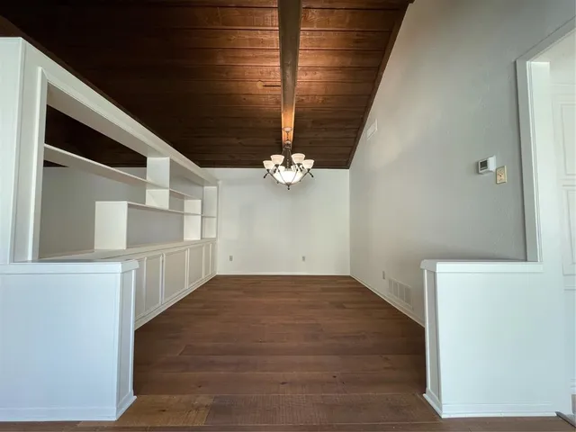 a view of a room with wooden floor