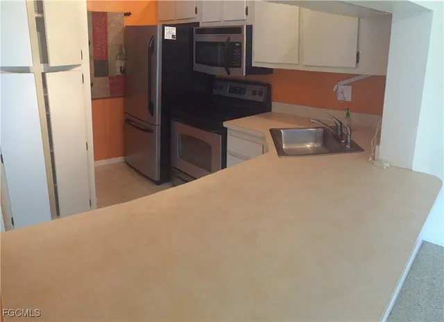 a kitchen with stainless steel appliances a refrigerator and stove