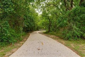 3 Abbey Road Euless, TX 76039 - Photo 6 of 12 access to Bob Eden Park from the community with Paved pathway bordered by abundant mature trees and dense foliage