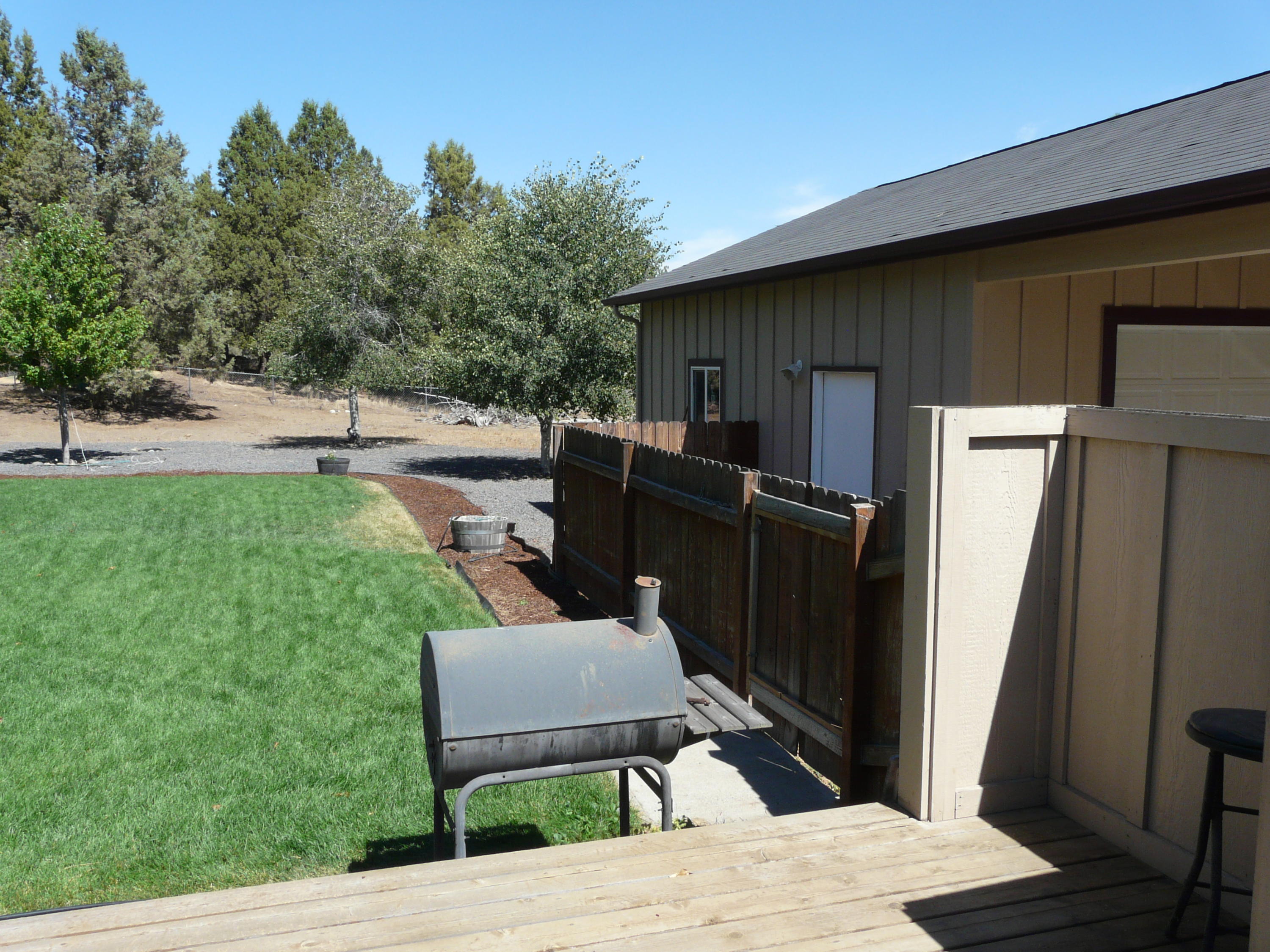 60872 Raintree Court Bend, OR 97702 - Photo 15 of 18 Garage and backyard. Fully fenced.