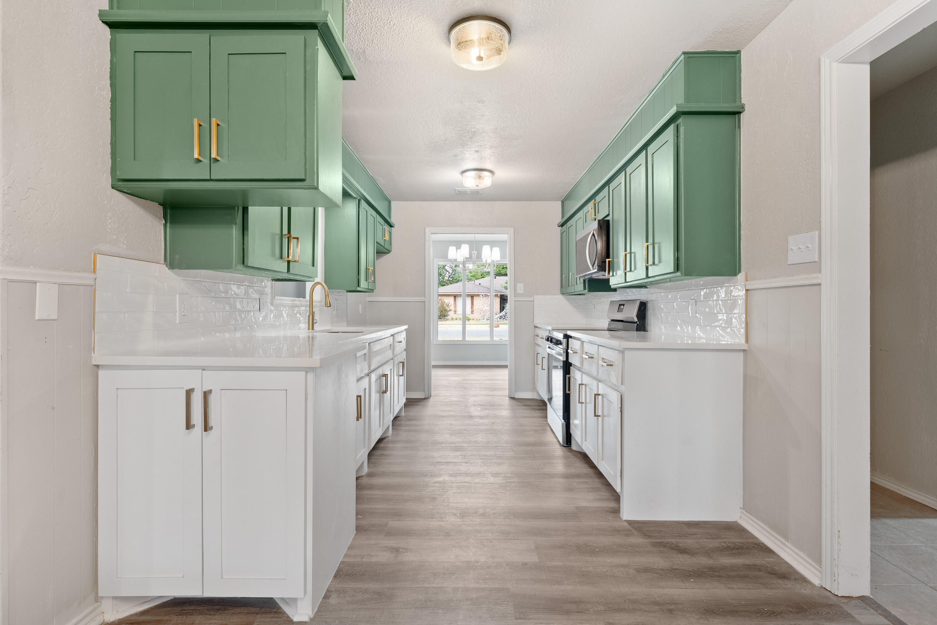 7902 Lynnhaven Avenue Lubbock, TX 79423 - Photo 11 of 35 a kitchen with white cabinets and white appliances