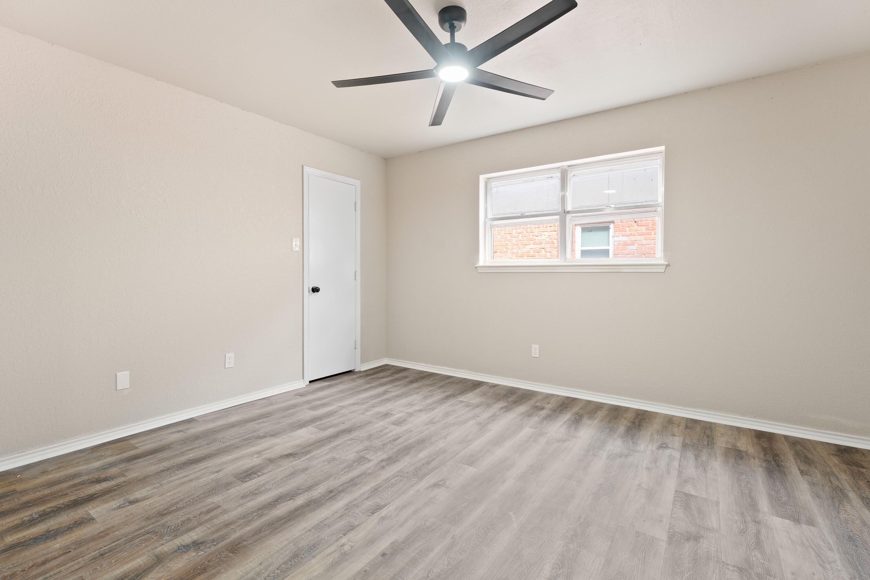 7902 Lynnhaven Avenue Lubbock, TX 79423 - Photo 21 of 35 wooden floor in an empty room with a window