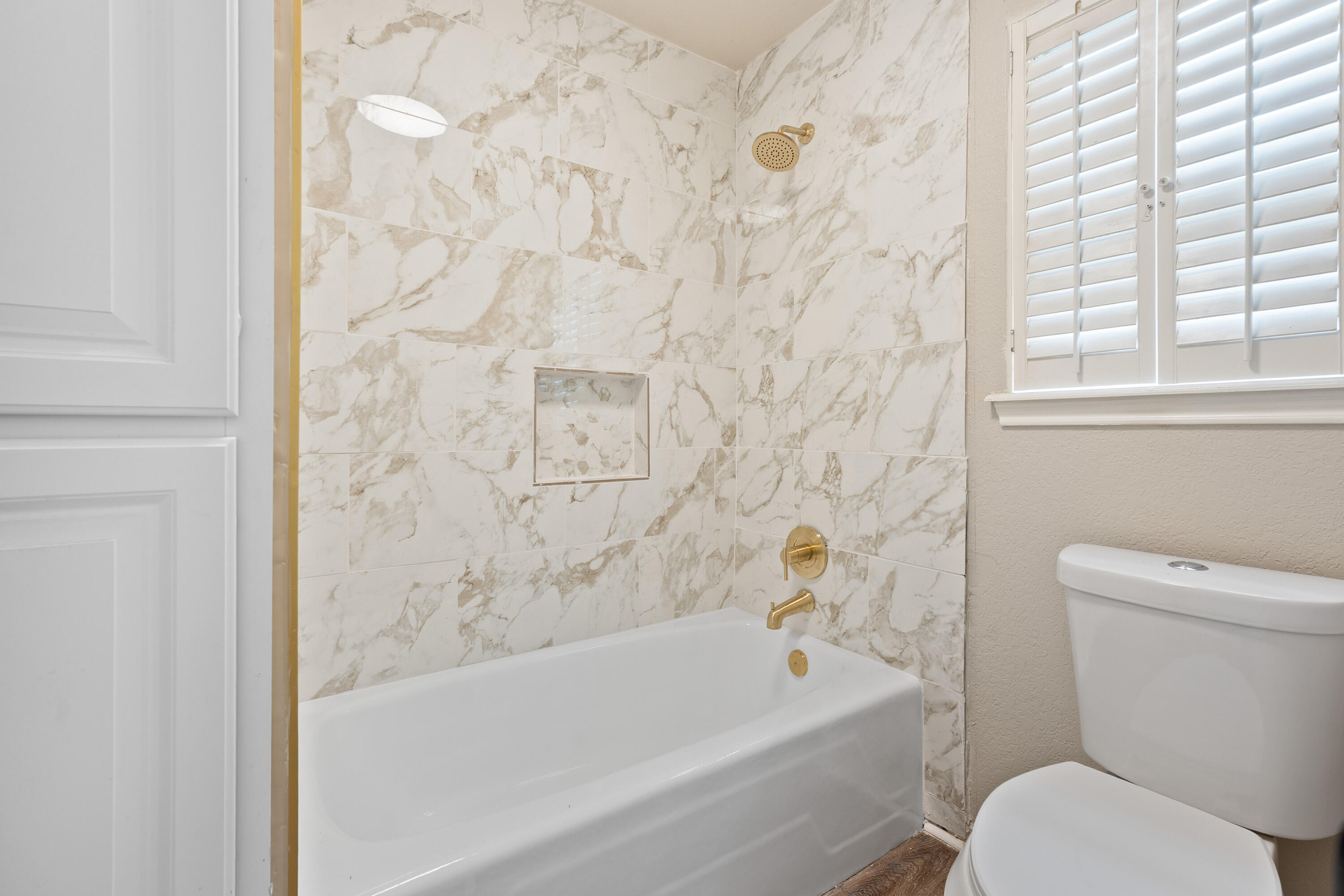 7902 Lynnhaven Avenue Lubbock, TX 79423 - Photo 25 of 35 a white bath tub sitting next to a white toilet